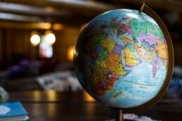 A globe in front of a brown background.