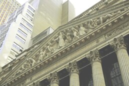 A close up, high-angle image of the New York Stock Exchange building's entrance.