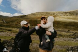 A family of three going for a hike to save money during their vacation